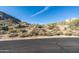 Street view of lot in desert community showcasing natural desert vegetation at 11130 E Rolling Rock Dr, Scottsdale, AZ 85262