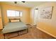 Cozy bedroom featuring wood paneling, plush carpet, and a comfortable queen-sized bed at 120 N Val Vista Dr # 230, Mesa, AZ 85213