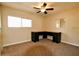 Neutral carpeted bedroom featuring a ceiling fan, two windows, and a desk setup at 120 N Val Vista Dr # 230, Mesa, AZ 85213