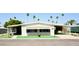 Charming single-story home featuring well-maintained landscaping with palm trees and covered parking at 120 N Val Vista Dr # 230, Mesa, AZ 85213