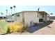 Back exterior of manufactured home featuring green grass and palm trees at 120 N Val Vista Dr # 230, Mesa, AZ 85213