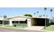 Beautiful home with a covered parking, offering shade and convenience, surrounded by palm trees at 120 N Val Vista Dr # 230, Mesa, AZ 85213