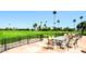 Inviting outdoor patio featuring wrought iron fencing with scenic views of the lush, green golf course at 120 N Val Vista Dr # 230, Mesa, AZ 85213