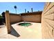 Outdoor hot tub area with surrounding brick walls and concrete flooring, perfect for relaxation at 120 N Val Vista Dr # 230, Mesa, AZ 85213