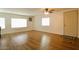 Inviting living room featuring hardwood floors, large windows providing ample natural light, and a ceiling fan at 120 N Val Vista Dr # 230, Mesa, AZ 85213