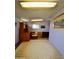 A home office features a wooden desk and chair, with a carpet rug on the floor at 120 N Val Vista Dr # 230, Mesa, AZ 85213