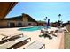 A community outdoor pool surrounded by lounge chairs and tables at 120 N Val Vista Dr # 230, Mesa, AZ 85213