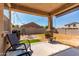 Backyard with covered patio, an outdoor dining area, and an artificial turf area at 12033 W Davis Ln, Avondale, AZ 85323
