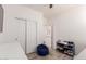 Bedroom featuring a closet, shoe rack, blue beanbag chair, and laminate flooring at 12033 W Davis Ln, Avondale, AZ 85323