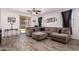 Spacious living room features stylish tile floors, a ceiling fan, and neutral tones at 12033 W Davis Ln, Avondale, AZ 85323