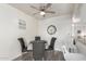 Bright dining room with modern ceiling fan and gray cushioned dining set near breakfast bar at 12123 W Bell Rd # 339, Surprise, AZ 85378