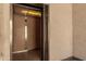 A stainless steel elevator door reveals an elevator with wood paneled walls and a ceiling light at 12123 W Bell Rd # 339, Surprise, AZ 85378