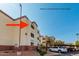 Building J southeast corner featuring well-maintained stucco, covered parking, and tidy landscaping against a clear blue sky at 12123 W Bell Rd # 339, Surprise, AZ 85378