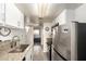 Long kitchen design featuring modern finishes, stainless steel appliances and luxury vinyl plank flooring at 12123 W Bell Rd # 339, Surprise, AZ 85378