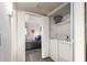 In-unit laundry room features a washer, dryer, and additional shelves for storage at 12123 W Bell Rd # 339, Surprise, AZ 85378