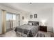Bright main bedroom with balcony access, gray color scheme and soft textures at 12123 W Bell Rd # 339, Surprise, AZ 85378
