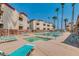 Community pool and hot tub with seating and mature landscaping at 12123 W Bell Rd # 339, Surprise, AZ 85378