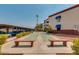 Community shuffleboard court with seating, covered parking and mature landscaping at 12123 W Bell Rd # 339, Surprise, AZ 85378