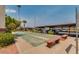Community shuffleboard court with seating, covered parking and mature landscaping at 12123 W Bell Rd # 339, Surprise, AZ 85378