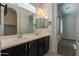 Bathroom features double sinks, dark wood cabinets, and a large mirror at 1367 S Country Club Dr # 1276, Mesa, AZ 85210