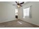 Bright bedroom featuring neutral walls, plush carpet, a window with blinds, and a view into the bathroom at 1367 S Country Club Dr # 1276, Mesa, AZ 85210
