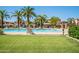 This community pool area offers seating and lush grassy areas for relaxation at 1367 S Country Club Dr # 1276, Mesa, AZ 85210