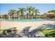 Community pool featuring a luxurious desert oasis with palm trees and several fountains at 1367 S Country Club Dr # 1276, Mesa, AZ 85210