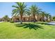 Beautiful landscaping featuring palm trees and a lush green lawn at 1367 S Country Club Dr # 1276, Mesa, AZ 85210