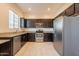 Spacious kitchen featuring stainless steel appliances, granite countertops, and ample cabinet space at 1367 S Country Club Dr # 1276, Mesa, AZ 85210