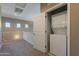 Hallway with stacked laundry units in open closet at 1367 S Country Club Dr # 1276, Mesa, AZ 85210
