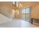 Bright living room with white tile floors, stairs to the second floor, and sliding doors leading to the backyard at 1367 S Country Club Dr # 1276, Mesa, AZ 85210