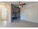 Open living room with feature wall, fireplace, and view into hallway at 1367 S Country Club Dr # 1276, Mesa, AZ 85210