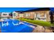 Stunning backyard featuring a sparkling pool, built-in bar and an outdoor living area at 13941 W Tierra Grande --, Surprise, AZ 85387