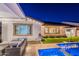 Luxurious backyard oasis with a covered patio, lush landscaping, and a sparkling pool at 13941 W Tierra Grande --, Surprise, AZ 85387