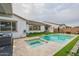 Beautiful backyard featuring a pool, spa, turf lawn, and outdoor seating area at 13941 W Tierra Grande --, Surprise, AZ 85387