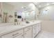 Bathroom with double sink vanity, large mirror, and tiled walls with modern fixtures at 13941 W Tierra Grande --, Surprise, AZ 85387