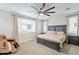 Spacious bedroom featuring a large bed, oversized ceiling fan, and bright windows at 13941 W Tierra Grande --, Surprise, AZ 85387