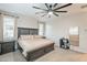 Cozy bedroom with large bed, neutral decor, bright windows, and an oversized ceiling fan at 13941 W Tierra Grande --, Surprise, AZ 85387