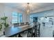 Open-concept dining area with views of a modern kitchen and an adjacent living area at 13941 W Tierra Grande --, Surprise, AZ 85387