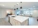 Bright open concept kitchen featuring large island with quartz countertop and modern pendant lighting at 13941 W Tierra Grande --, Surprise, AZ 85387