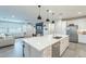 Open-concept kitchen features stainless steel appliances, white cabinets, and a large island at 13941 W Tierra Grande --, Surprise, AZ 85387