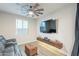 Modern living room features a ceiling fan, large tv, and cozy leather seating at 13941 W Tierra Grande --, Surprise, AZ 85387