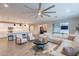 An open-concept living area with a large sectional sofa, stylish seating and open sightlines at 13941 W Tierra Grande --, Surprise, AZ 85387