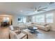 Spacious open-concept living room with a large sectional sofa, and a stylish ceiling fan at 13941 W Tierra Grande --, Surprise, AZ 85387