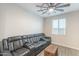 This living room features a large leather sectional, ceiling fan, and woven storage at 13941 W Tierra Grande --, Surprise, AZ 85387