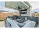 Well-equipped outdoor kitchen with built-in grill, lounge area, and ceiling fan at 13941 W Tierra Grande --, Surprise, AZ 85387