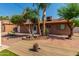 Backyard area with a deck, brick accents, and mature landscaping at 1448 E Royal Palm Rd, Phoenix, AZ 85020