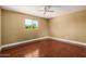 Cozy bedroom features hardwood floors, base molding and a large window at 1448 E Royal Palm Rd, Phoenix, AZ 85020