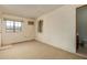 Bonus room features white brick walls, carpeting, two windows, and a sink and toilet in the corner at 1448 E Royal Palm Rd, Phoenix, AZ 85020