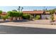 Charming single-story home with desert landscaping, mature trees and pavers leading to the front door at 1448 E Royal Palm Rd, Phoenix, AZ 85020